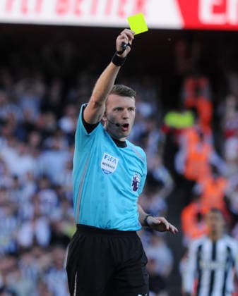Football - 2025 2026 Premier League - Arsenal vs. Newcastle United - Emirates Stadium - Saturday 25th April 2026 Newcastle goalkeeper, Nick Pope receives a yellow card from referee Sam Barrett for fouling Viktor Gyokeres of Arsenal outside the box 