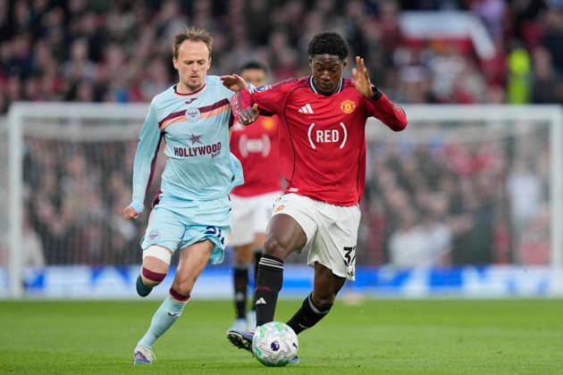 27th April 2026; Old Trafford, Manchester, England; Premier League Football, Manchester United, ManU versus Brentford; Kobbie Mainoo of Manchester United makes a break past Mikkel Damsgaard of Brentford StevexFlynn