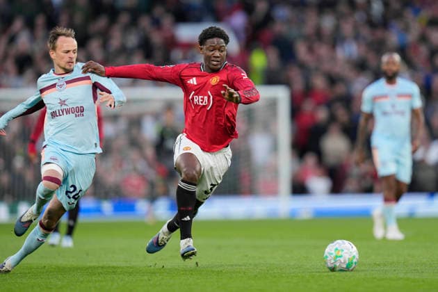 27th April 2026; Old Trafford, Manchester, England; Premier League Football, Manchester United, ManU versus Brentford; Kobbie Mainoo of Manchester United makes a break past Mikkel Damsgaard of Brentford StevexFlynn