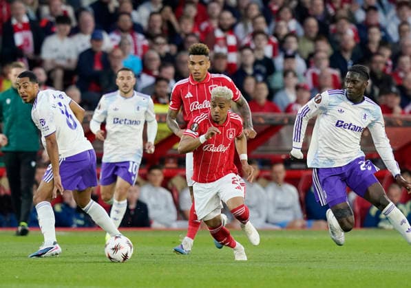 Nottingham, England, 30th April 2026. Omari Hutchinson of Nottingham Forest (c) makes a break past Amadou Onana of Aston Villa (r) during the Nottingham Forest vs Aston Villa UEFA Europa League Semi Final 1st leg match at the City Ground, Nottingham. Picture credit should read: Andrew Yates Sportimage EDITORIAL USE ONLY. No use with unauthorised audio, video, data, fixture lists, club league logos or live services. Online in-match use limited to 120 images, no video emulation. No use in betting, games or single club league player publications. SPI_042_AY_Forest_Villa SPI-4767-0042
