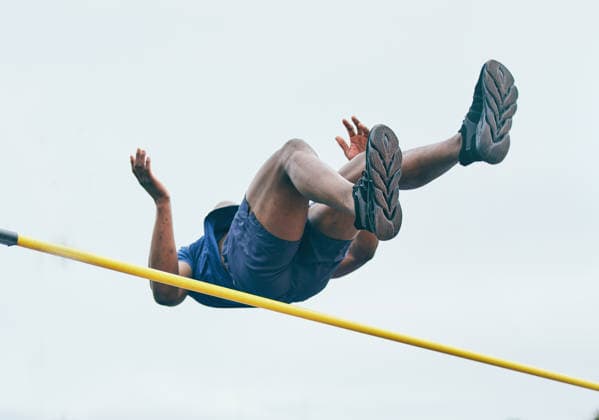 Fitness, athletics high jump by man at a stadium for training, energy and cardio against sky background. Jumping, athlete and male outdoors for performance, endurance and competition on mock up. (License=RF) 19797091 ,model released, Symbolfoto  Copyright: xZoonar.com YurixArcursxpeopleimages.comx 19797091 ,model released, Symbolfoto ,property released