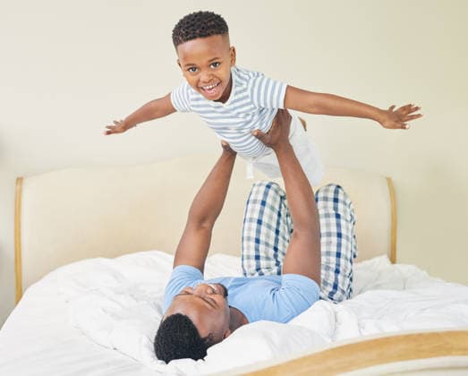 Every child wishes they could fly. a young father lying down and bonding with his son while playing with him at home (License=RF) 19816297 ,model released, Symbolfoto  Copyright: xZoonar.com YurixArcursxpeopleimages.comx 19816297 ,model released, Symbolfoto ,property released