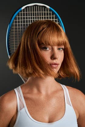 If you feel good then you play good. a young woman posing with a tennis racket against a dark background (License=RF) 19844533 ,model released, Symbolfoto  Copyright: xZoonar.com YurixArcursxpeopleimages.comx 19844533 ,model released, Symbolfoto ,property released