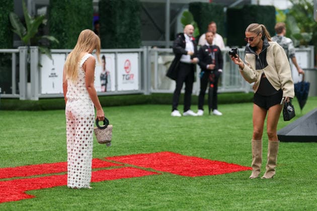 RECORD DATE NOT STATED 3rd May 2026; Miami International Autodrome, Miami, Florida, United States of America; 2026 FIA Formula 1 Miami Grand Prix Race Day; fans take photos over the F1 logo painted on the grass in team village DavidxBuono