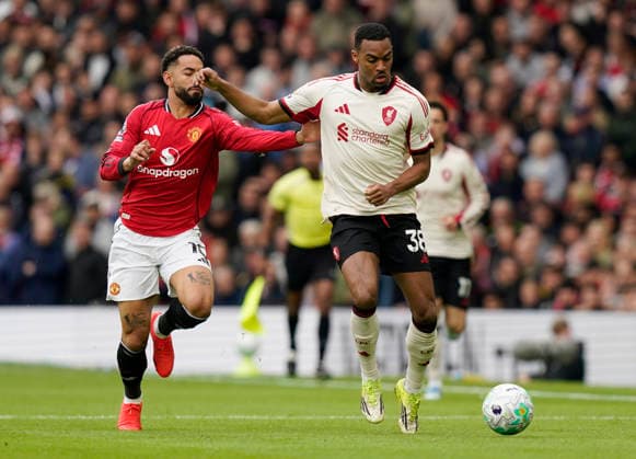 Manchester, England, 3rd May 2026. Matheus Cunha of Manchester United, ManU gets caught in the face by Ryan Gravenberch of Liverpool during the Manchester United vs Liverpool Premier League match at Old Trafford, Manchester. Picture credit should read: Andrew Yates Sportimage EDITORIAL USE ONLY. No use with unauthorised audio, video, data, fixture lists, club league logos or live services. Online in-match use limited to 120 images, no video emulation. No use in betting, games or single club league player publications. SPI_022_AY_MAN_UTD_LIVERPOOL SPI-4776-0022