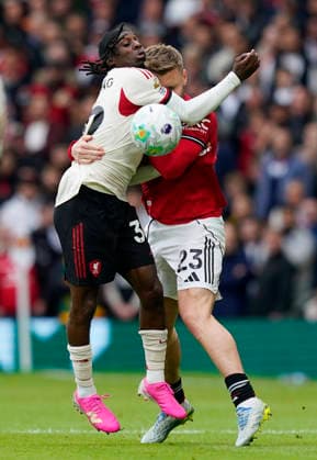 Manchester, England, 3rd May 2026. Jeremie Frimpong of Liverpool tussles with Luke Shaw of Manchester United, ManU Ä™ during the Manchester United vs Liverpool Premier League match at Old Trafford, Manchester. Picture credit should read: Andrew Yates Sportimage EDITORIAL USE ONLY. No use with unauthorised audio, video, data, fixture lists, club league logos or live services. Online in-match use limited to 120 images, no video emulation. No use in betting, games or single club league player publications. SPI_059_AY_MAN_UTD_LIVERPOOL SPI-4776-0058