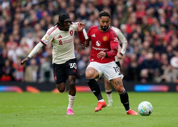 Manchester, England, 3rd May 2026. Jeremie Frimpong of Liverpool tussles with Matheus Cunha of Manchester United, ManU during the Manchester United vs Liverpool Premier League match at Old Trafford, Manchester. Picture credit should read: Andrew Yates Sportimage EDITORIAL USE ONLY. No use with unauthorised audio, video, data, fixture lists, club league logos or live services. Online in-match use limited to 120 images, no video emulation. No use in betting, games or single club league player publications. SPI_061_AY_MAN_UTD_LIVERPOOL SPI-4776-0060