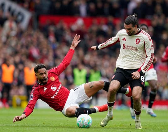 Manchester, England, 3rd May 2026. Matheus Cunha of Manchester United, ManU tussles with Dominik Szoboszlai of Liverpool during the Manchester United vs Liverpool Premier League match at Old Trafford, Manchester. Picture credit should read: Andrew Yates Sportimage EDITORIAL USE ONLY. No use with unauthorised audio, video, data, fixture lists, club league logos or live services. Online in-match use limited to 120 images, no video emulation. No use in betting, games or single club league player publications. SPI_064_AY_MAN_UTD_LIVERPOOL SPI-4776-0063