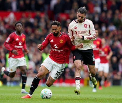 Manchester, England, 3rd May 2026. Matheus Cunha of Manchester United, ManU tussles with Dominik Szoboszlai of Liverpool during the Manchester United vs Liverpool Premier League match at Old Trafford, Manchester. Picture credit should read: Andrew Yates Sportimage EDITORIAL USE ONLY. No use with unauthorised audio, video, data, fixture lists, club league logos or live services. Online in-match use limited to 120 images, no video emulation. No use in betting, games or single club league player publications. SPI_065_AY_MAN_UTD_LIVERPOOL SPI-4776-0064