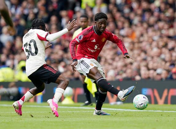 Manchester, England, 3rd May 2026. Kobbie Mainoo of Manchester United, ManU (r) and Jeremie Frimpong of Liverpool (r) during the Manchester United vs Liverpool Premier League match at Old Trafford, Manchester. Picture credit should read: Andrew Yates Sportimage EDITORIAL USE ONLY. No use with unauthorised audio, video, data, fixture lists, club league logos or live services. Online in-match use limited to 120 images, no video emulation. No use in betting, games or single club league player publications. SPI_067_AY_MAN_UTD_LIVERPOOL SPI-4776-0067