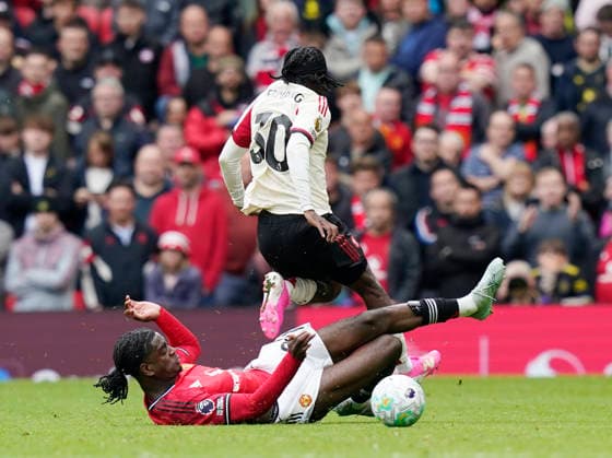 Manchester, England, 3rd May 2026. Ayden Heaven of Manchester United, ManU tackles Jeremie Frimpong of Liverpool during the Manchester United vs Liverpool Premier League match at Old Trafford, Manchester. Picture credit should read: Andrew Yates Sportimage EDITORIAL USE ONLY. No use with unauthorised audio, video, data, fixture lists, club league logos or live services. Online in-match use limited to 120 images, no video emulation. No use in betting, games or single club league player publications. SPI_070_AY_MAN_UTD_LIVERPOOL SPI-4776-0069