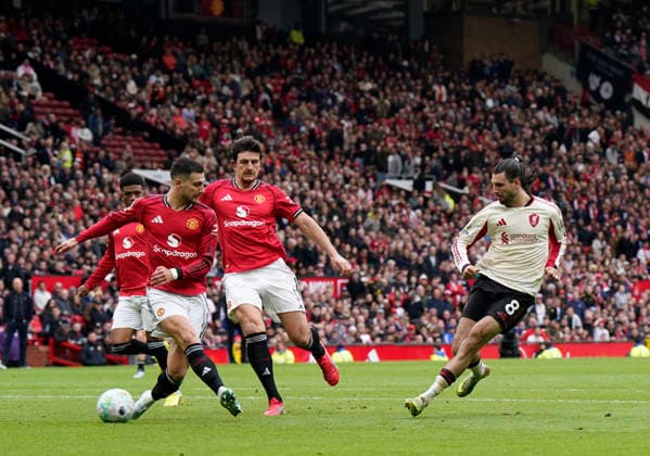 Manchester, England, 3rd May 2026. Dominik Szoboszlai of Liverpool (r) scores their first goal (2-1) during the Manchester United, ManU vs Liverpool Premier League match at Old Trafford, Manchester. Picture credit should read: Andrew Yates Sportimage EDITORIAL USE ONLY. No use with unauthorised audio, video, data, fixture lists, club league logos or live services. Online in-match use limited to 120 images, no video emulation. No use in betting, games or single club league player publications. SPI_077_AY_MAN_UTD_LIVERPOOL SPI-4776-0076