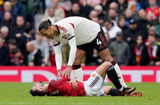 Manchester, England, 3rd May 2026. Virgil van Dijk of Liverpool smiles as he looks down on an injured Bruno Fernandes of Manchester Unitedduring the Manchester United, ManU vs Liverpool Premier League match at Old Trafford, Manchester. Picture credit should read: Andrew Yates Sportimage EDITORIAL USE ONLY. No use with unauthorised audio, video, data, fixture lists, club league logos or live services. Online in-match use limited to 120 images, no video emulation. No use in betting, games or single club league player publications. SPI_089_AY_MAN_UTD_LIVERPOOL SPI-4776-0088