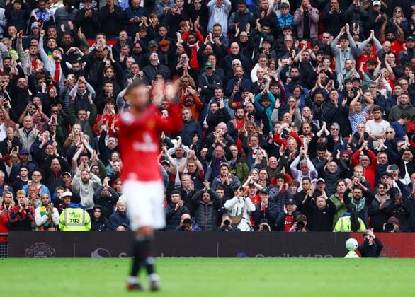 Manchester United, ManU fans applaud behind Bruno Fernandes Manchester United v Liverpool, Premier League, Football, Old Trafford, Manchester , UK - 03 May 2026Manchester Old Trafford United Kingdom EDITORIAL USE ONLY No use with unauthorised audio, video, data, fixture lists, club league logos or live services. Online in-match use limited to 120 images, no video emulation. No use in betting, games or single club league player publications. Copyright: xMattxWest Shutterstockx 16854589ay