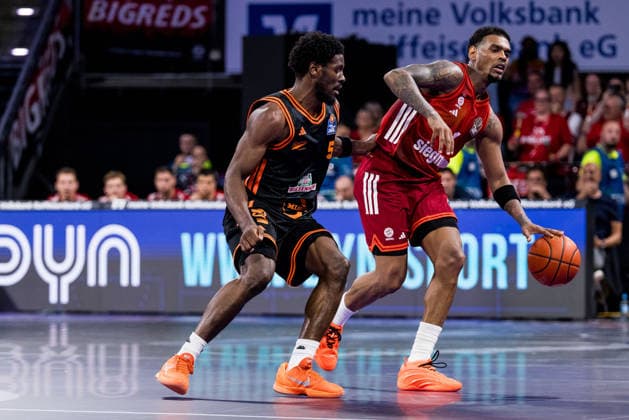 MUNICH, GERMANY - MAY 03: Xavier Rathan-Mayes (FC Bayern Muenchen, 4) controls the ball against TJ Bamba (Rasta Vechta, 5) during the easyCredit Basketball Bundesliga match between FC Bayern Muenchen vs. Rasta Vechta at BMW Park on matchday 32 of the easyCredit Basketball Bundesliga on May 03, 2026 in Munich, Germany. Bavaria Germany Copyright: xSteffiexWunderlx