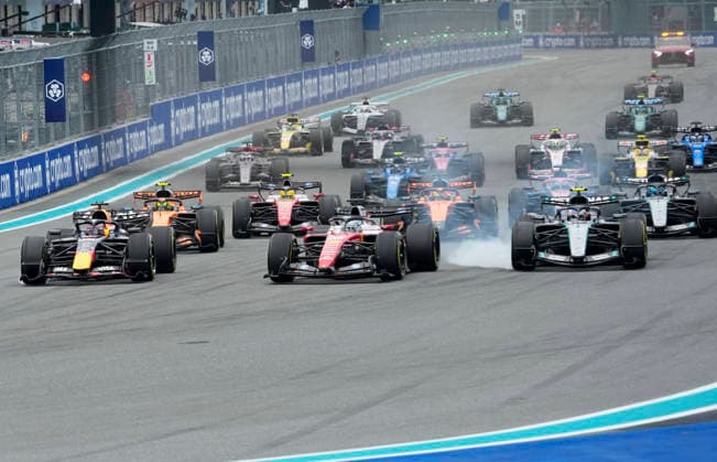 Drivers head into the first turn at the start of the Formula One Miami Grand Prix at the Miami International Autodrome in Miami Gardens, Florida on Sunday, May 3, 2026.  MIA20260503905 GREGxNASH