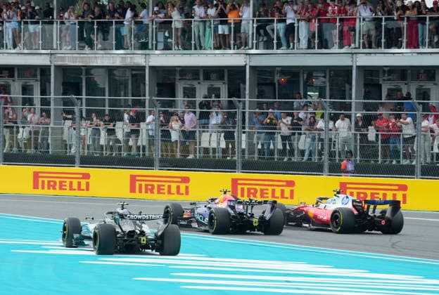 Monaco s Ferrari driver Charles Leclerc leads McLaren driver Lando Norris of Britain and Mercedes-AMG Petronas driver Kimi Antonelli of Italy into the first turn at the start of the Formula One Miami Grand Prix at the Miami International Autodrome in Miami Gardens, Florida on Sunday, May 3, 2026.  MIA20260503906 GREGxNASH