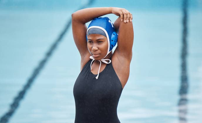 Water polo, Wasserball sports and stretching with black woman at swimming pool for health, workout and fitness. Wellness, relax and warm up with arm of girl athlete for cardio, training and exercise goals. (License=RF) 19845439 ,model released, Symbolfoto  Copyright: xZoonar.com YurixArcursxpeopleimages.comx 19845439 ,model released, Symbolfoto ,property released