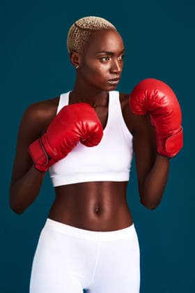 I am proud but never satisfied. an attractive young female boxer working out against a dark background in the studio (License=RF) 19848677 ,model released, Symbolfoto  Copyright: xZoonar.com YurixArcursxpeopleimages.comx 19848677 ,model released, Symbolfoto ,property released