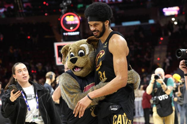 Cleveland Cavaliers Jarrett Allen (31) gets a hug from Cavaliers mascot Moondog after defeating the Toronto Raptors 114-102 in Cleveland, Ohio Sunday May 3, 2026.  CLE20260503117 AARONxJOSEFCZYK