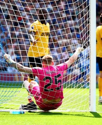 Daniel Bentley of Wolverhampton Wanderers falls into the net after making a save from Danny Welbeck of Brighton and Hove Albion. Brighton and Hove Albion v Wolverhampton Wanderers, Premier League, Football, American Express Community Stadium, Brighton , UK - 09 May 2026Brighton American Express Community Stadi United Kingdom EDITORIAL USE ONLY No use with unauthorised audio, video, data, fixture lists, club league logos or live services. Online in-match use limited to 120 images, no video emulation. No use in betting, games or single club league player publications. Copyright: xJamesxMarsh Shutterstockx 16861685aj