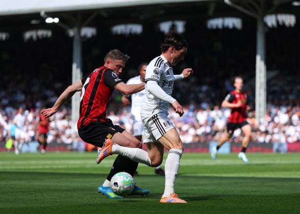 9th May 2026; Craven Cottage, Fulham, London, England; Premier League Football, Fulham versus Bournemouth; Harry Wilson of Fulham under pressure from Adrien Truffert of AFC Bournemouth JPxFletcher