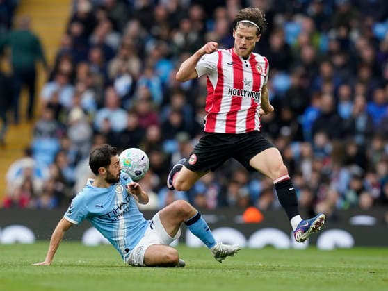 Manchester, England, 9th May 2026. Mathias Jensen of Brentford (R) is challenged by Bernardo Silva of Manchester City during the Manchester City vs Brentford Premier League match at the Etihad Stadium, Manchester. Picture credit should read: Andrew Yates Sportimage EDITORIAL USE ONLY. No use with unauthorised audio, video, data, fixture lists, club league logos or live services. Online in-match use limited to 120 images, no video emulation. No use in betting, games or single club league player publications. SPI_024_AY_MAN_CITY_BRENTFORD SPI-4788-0028