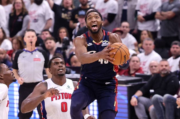 Cleveland Cavaliers Donovan Mitchell (45) adjusts his shot to avoid Detroit Pistons Jalen Duren (0) in the fourth quarter in Cleveland, Ohio Saturday May 9, 2026. The Cavaliers defeated the Pistons 116-109.  CLE20260509120 AARONxJOSEFCZYK