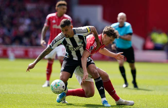 Nottingham, England, 10th May 2026. Bruno Guimaraes of Newcastle United (L) challenges Ryan Yates of Nottingham Forest during the Nottingham Forest vs Newcastle United Premier League match at the City Ground, Nottingham. Picture credit should read: Andrew Yates Sportimage EDITORIAL USE ONLY. No use with unauthorised audio, video, data, fixture lists, club league logos or live services. Online in-match use limited to 120 images, no video emulation. No use in betting, games or single club league player publications. SPI_022_AY_NOTTS_FOREST_NEWC SPI-4792-0022