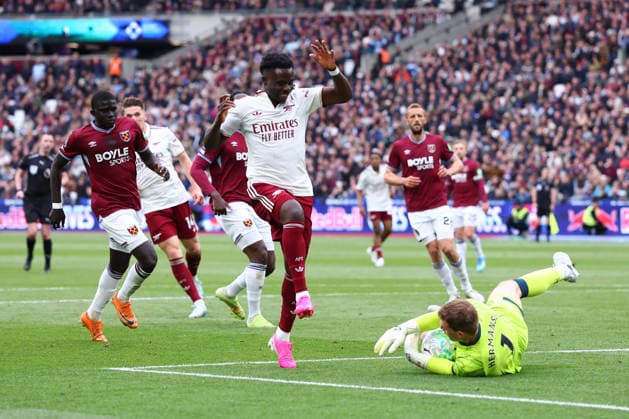 London, England, 10th May 2026. Mads Hermansen of West Ham United collects the ball ahead of Bukayo Saka of Arsenal during the West Ham United vs Arsenal Premier League match at the London Stadium, London. Picture credit should read: Paul Terry Sportimage EDITORIAL USE ONLY. No use with unauthorised audio, video, data, fixture lists, club league logos or live services. Online in-match use limited to 120 images, no video emulation. No use in betting, games or single club league player publications. SPI_032_PT_West_Ham_Arsenal SPI-4793-0032