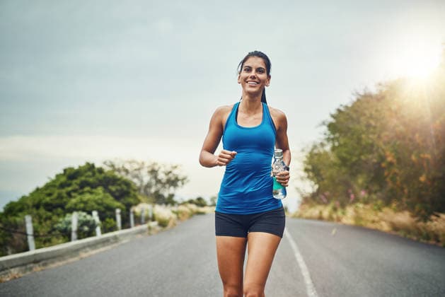 Fitness, happy woman and running with water bottle for exercise, cardio or wellness on road in nature. Female athlete, smile or workout on trail for health, or marathon training with sportswear. (License=RF) 21834404 ,model released, Symbolfoto  Copyright: xZoonar.com YurixArcursx 21834404 ,model released, Symbolfoto ,property released