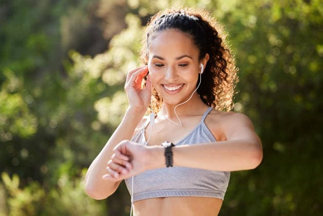 Music, time and watch with runner woman outdoor in park for summer fitness, training or workout. Improvement, progress and tracking with happy sports athlete running in nature for cardio exercise. (License=RF) 21837161 ,model released, Symbolfoto  Copyright: xZoonar.com YurixArcursxpeopleimages.comx 21837161 ,model released, Symbolfoto ,property released