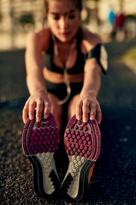 Girl, runner and stretching legs on ground, outdoor and warm up for exercise or fitness training. Female person, earphones and athlete for cardio preparation, muscle flexibility and music for workout. (License=RF) 21844815 ,model released, Symbolfoto  Copyright: xZoonar.com YurixArcursx 21844815 ,model released, Symbolfoto ,property released