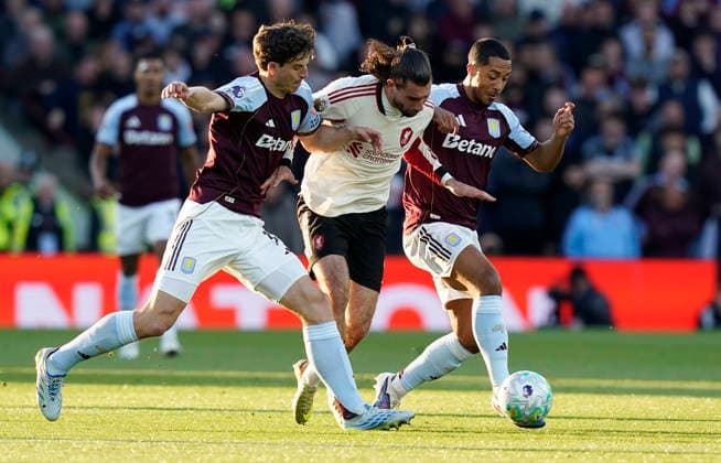 Birmingham, England, 15th May 2026. Dominik Szoboszlai of Liverpool (C) is challenged by Pau Torres of Aston Villa (L) and Youri Tielemans of Aston Villa during the Aston Villa vs Liverpool Premier League match at Villa Park, Birmingham. Picture credit should read: Andrew Yates Sportimage EDITORIAL USE ONLY. No use with unauthorised audio, video, data, fixture lists, club league logos or live services. Online in-match use limited to 120 images, no video emulation. No use in betting, games or single club league player publications. SPI_013_AY_ASTON_VILLA_LIVERPOOL SPI-4802-0013