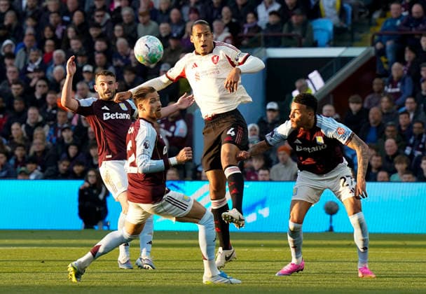 Birmingham, England, 15th May 2026. Virgil van Dijk of Liverpool (C) wins a header during the Aston Villa vs Liverpool Premier League match at Villa Park, Birmingham. Picture credit should read: Andrew Yates Sportimage EDITORIAL USE ONLY. No use with unauthorised audio, video, data, fixture lists, club league logos or live services. Online in-match use limited to 120 images, no video emulation. No use in betting, games or single club league player publications. SPI_015_AY_ASTON_VILLA_LIVERPOOL SPI-4802-0015