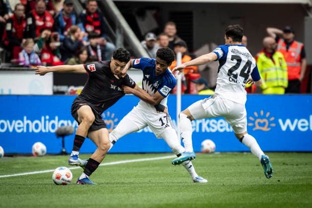 LEVERKUSEN, GERMANY - MAY 16, 2026 : Ibrahim Maza (Bayer 04 Leverkusen, 30) tackled by Warmed Omari (Hamburger SV, 17) and Nicolas Capaldo (Hamburger SV, 24) during the German Bundesliga match on gameday 34 between Bayer 04 Leverkusen vs. Hamburger SV at BayArena on May 16, 2026 in Leverkusen, Germany. DFL REGULATIONS PROHIBIT ANY USE OF PHOTOGRAPHS AS IMAGE SEQUENCES AND OR QUASI-VIDEO. Northrhine-Westphalia Germany Copyright: xAxelxKohringx