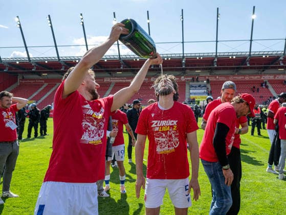 Fussball, Herren, Saison 2025 2026, 3. Liga (38. Spieltag), SSV Jahn Regensburg - FC Energie Cottbus, v.l. Tim Campulka (Energie Cottbus), Dominik Pelivan (Energie Cottbus), Jubel nach Abpfiff mit Champagner, 16.05. 2026, Copyright: xSebastianxRäppold MatthiasxKochx