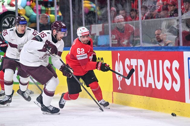 ZURICH, SWITZERLAND - MAY 16: Oskars Batna of Latvia L) and Denis Malgin of Switzerland R) chase the puck during the 2026 IIHF Ice hockey, Eishockey World Championship, WM, Weltmeisterschaft Switzerland game between Switzerland and Latvia at Swiss Life Arena on May 16, 2026 in Zurich, Zurich. Zurich Swiss Life Arena Zurich Switzerland Copyright: xJustPictures.ch AndreaxBrancax jp-en-EuSpIm-JP7_ANB_Sui_Lat_16052026_3694