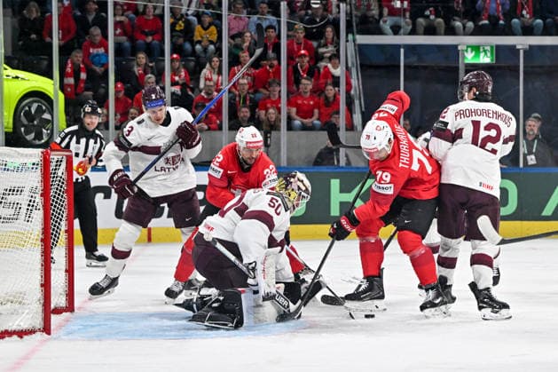 ZURICH, SWITZERLAND - MAY 16: Calvin Thurkauf of Switzerland R) and Nino Niederreiter of Switzerland L) in a battle for the puck against goalkeeper Kristers Gudlevskis of Latvia during the 2026 IIHF Ice hockey, Eishockey World Championship, WM, Weltmeisterschaft Switzerland game between Switzerland and Latvia at Swiss Life Arena on May 16, 2026 in Zurich, Zurich. Zurich Swiss Life Arena Zurich Switzerland Copyright: xJustPictures.ch AndreaxBrancax jp-en-EuSpIm-JP7_ANB_Sui_Lat_16052026_4883