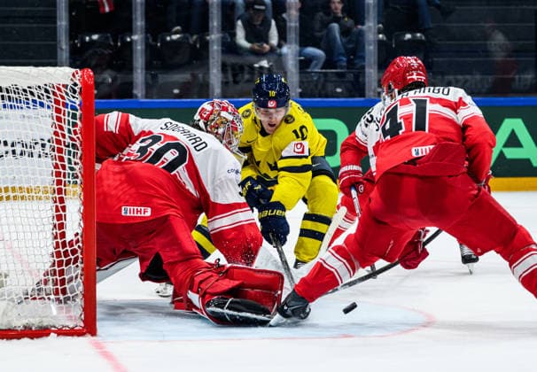 260517 Goaltender Mads Sogaard and Jesper Jensen-Aabo of Denmark compete for the puck with Simon Holmström of Sweden during the 2026 IIHF Ice hockey, Eishockey World Championship, WM, Weltmeisterschaft match between Denmark and Sweden on May 17, 2026 in Fribourg. Photo: Jesper Zerman BILDBYRAN kod JZ JZ0716 ishockey ice hockey ishockey-vm 2026 vm 2026 iihf world championship danmark denmark sverige sweden bbeng Copyright: JESPERxZERMAN BB260517JZ059