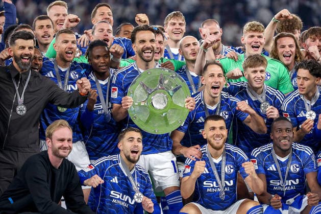 17.05.2026, Fußball, FC Schalke 04 - Eintracht Braunschweig, 34. Spieltag, 2. Fußball Bundesliga, Veltins-Arena Gelsenkirchen, Saison 2025 2026: Schalke 04 ist Meister der 2. Bundesliga. Die Mannschaft gewinnt die Meisterschaft und steht jubelnd auf dem Spielfeld. Freude und Emotionen nach dem Sieg. Gruppenbild Mannschaftsbild mit Kenan Karaman (Schalke04 19) mit der Meisterschale DFB regulations prohibit any use of photographs as image sequences and or quasi-video. Nordrhein-Westfalen Deutschland