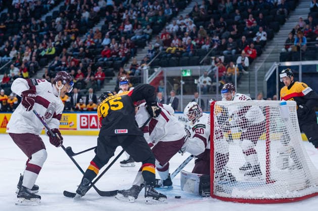 ZURICH, SWITZERLAND - MAY 17: Kristers Gudlevskis (Latvia, 50) safes the puck from Frederick Tiffels (Germany, 95) during the Preliminary Round - Group A Match 15 between Germany and Latvia at the IIHF Ice hockey, Eishockey World Championship, WM, Weltmeisterschaft 2026, Swiss Life Arena on May 17, 2026 in Zurich, Switzerland. Zurich Switzerland Copyright: xTimoxSteinx