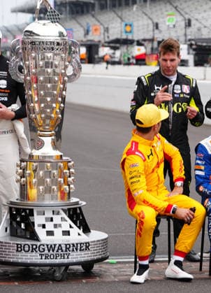 INDIANAPOLIS, IN - MAY 18: IndyCar, Indy Car, IRL, USA driver Alex Palou sitting in yellow driver suit talks to driver Will Power before a group driver photo is taken before practice for the 110th Running of the Indianapolis 500 on May 18th, 2026, at the Indianapolis Motor Speedway in Indianapolis, Indiana. (Photo by Brian Spurlock Icon Sportswire) AUTO: MAY 18 NTT IndyCar Series Indianapolis 500 Practice EDITORIAL USE ONLY Icon2605185009