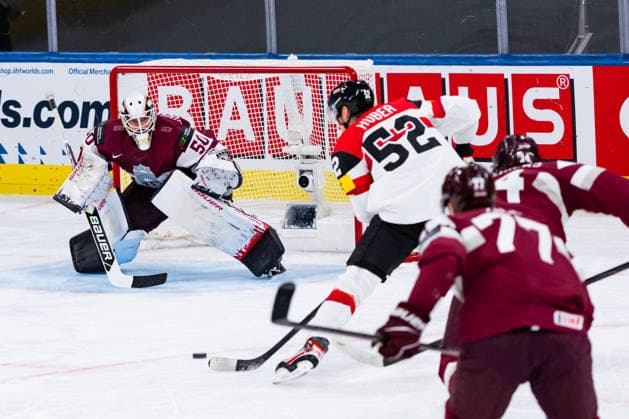 ZURICH, SWITZERLAND - MAY 19: Paul Huber (Austria, 52) in front of of Kristers Gudlevskis (Latvia, 50) during the Preliminary Round - Group A Match 21 between Latvia and Austria at the IIHF Ice hockey, Eishockey World Championship, WM, Weltmeisterschaft 2026, Swiss Life Arena on May 19, 2026 in Zurich, Switzerland. Zurich Switzerland Copyright: xTimoxSteinx