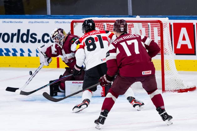 ZURICH, SWITZERLAND - MAY 19: Kristers Gudlevskis (Latvia, 50), Martins Dzierkals (Latvia, 17) against Leon Kolarik (Austria, 81) during the Preliminary Round - Group A Match 21 between Latvia and Austria at the IIHF Ice hockey, Eishockey World Championship, WM, Weltmeisterschaft 2026, Swiss Life Arena on May 19, 2026 in Zurich, Switzerland. Zurich Switzerland Copyright: xTimoxSteinx