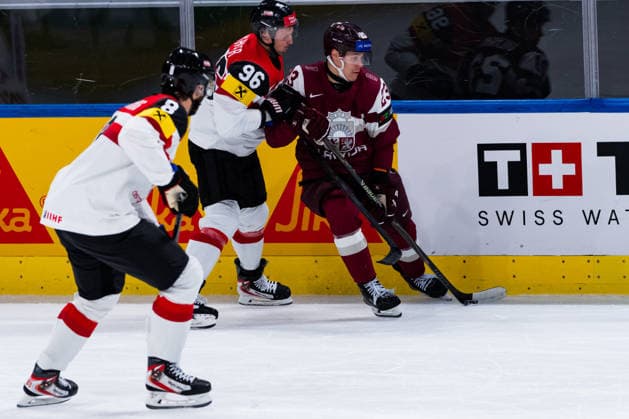 ZURICH, SWITZERLAND - MAY 19: Mario Huber (Austria, 96) in the battle for the puck with Sandis Vilmanis (Latvia, 23) during the Preliminary Round - Group A Match 21 between Latvia and Austria at the IIHF Ice hockey, Eishockey World Championship, WM, Weltmeisterschaft 2026, Swiss Life Arena on May 19, 2026 in Zurich, Switzerland. Zurich Switzerland Copyright: xTimoxSteinx