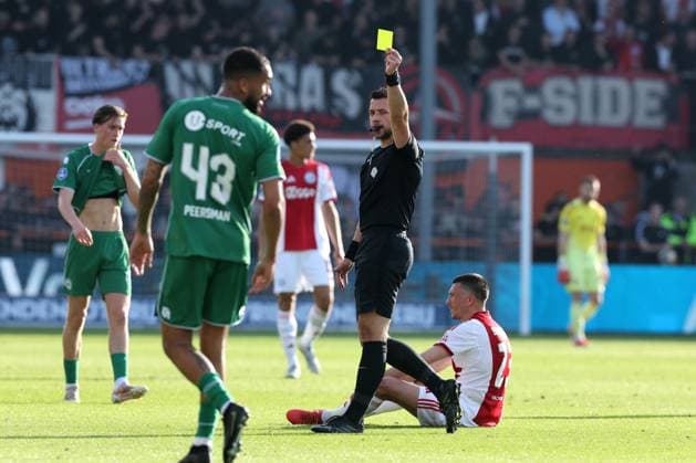 VOLENDAM - (lr) Referee Marc Nagtegaal issues a yellow card during the Dutch Eredivisie match between Ajax and FC Groningen at Kras Stadium on May 21, 2026 in Volendam, the Netherlands. (Photo by DeFodi Images) -