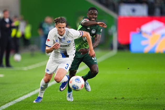 21.05.2026, xydrx, Herren, Fußball, Relegation Hinspiel, 1.Bundesliga, VfL Wolfsburg - SC Paderborn 07, Saison 2025 2026, Volkswagen Arena: Jonah Sticker (SC Paderborn, 3) im Zweikampf gegen Sael Kumbedi (VfL Wolfsburg, 26) DFB regulations prohibit any use of photographs as image sequences and or quasi-video. Copyright: HMBxMedia YannisxDreimann