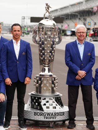 INDIANAPOLIS, IN - MAY 22: From left to right time Indy 500 winners Hello Castroneves and Rick Mears pose with the Borg Warner Trophy on the yard of bricks during Miller Lite Carb Day for the 110th Running of the Indianapolis 500 on May 22, 2026, at the Indianapolis Motor Speedway in Indianapolis, Indiana. (Photo by Brian Spurlock Icon Sportswire) AUTO: MAY 22 NTT IndyCar, Indy Car, IRL, USA Series Miller Lite Carb Day EDITORIAL USE ONLY Icon26052250066