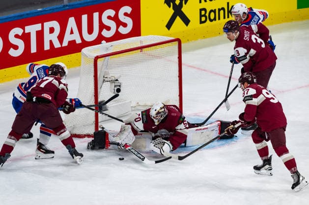 ZURICH, SWITZERLAND - MAY 23: Kristers Gudlevskis (Latvia, 50) keeping the puck from Ryan Leonard (United States, 9) during the Preliminary Round - Group A Match 37 between Latvia and United States at the IIHF Ice hockey, Eishockey World Championship, WM, Weltmeisterschaft 2026, Swiss Life Arena on May 23, 2026 in Zurich, Switzerland. Zurich Switzerland Copyright: xTimoxSteinx